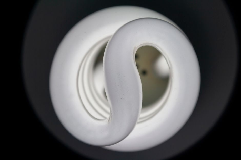 Detailed view of a spiral CFL bulb showcasing its elegant design and artistic lighting effect.