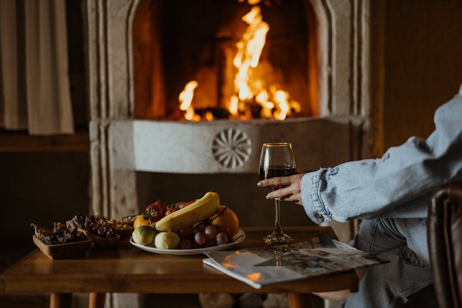 Relaxing by a warm fireplace with a glass of wine and fruit platter.