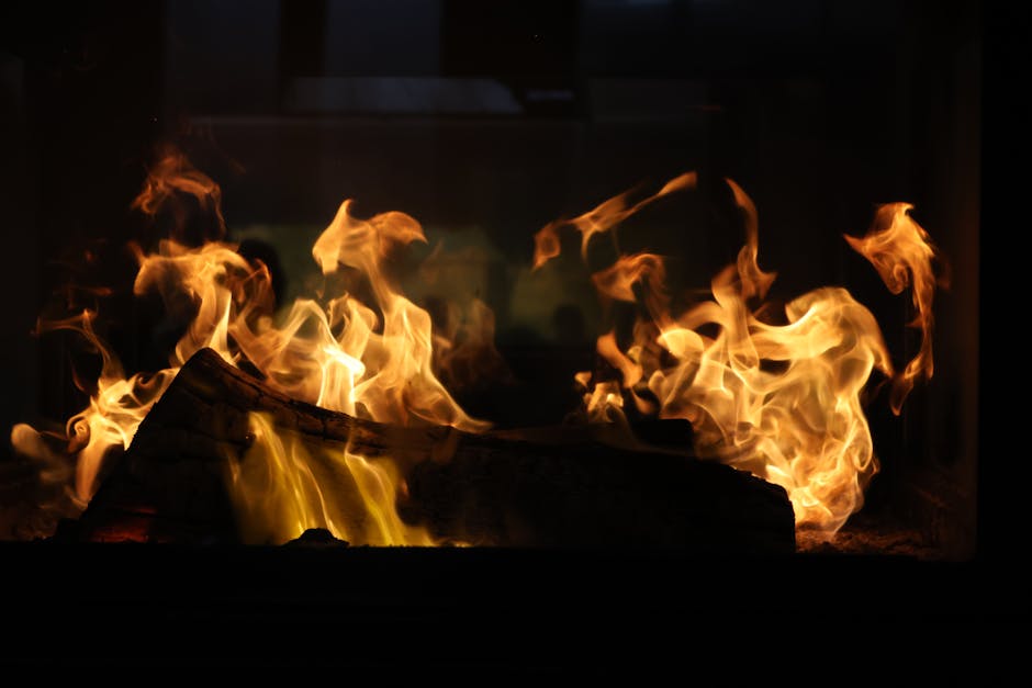 Captivating image of vibrant flames dancing in a rustic fireplace, creating a warm ambiance.