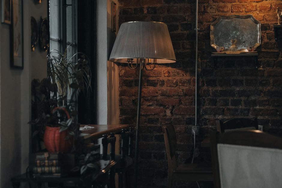 Warm and inviting living room with vintage decor and soft lamp lighting.