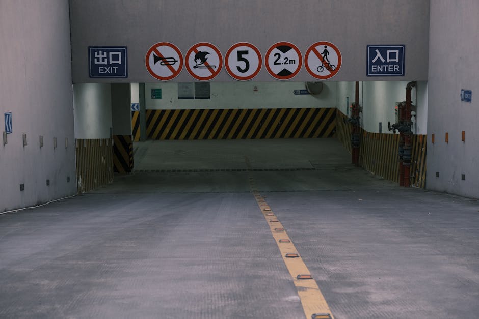 Entrance to underground parking with clear prohibition signs and exit markings.