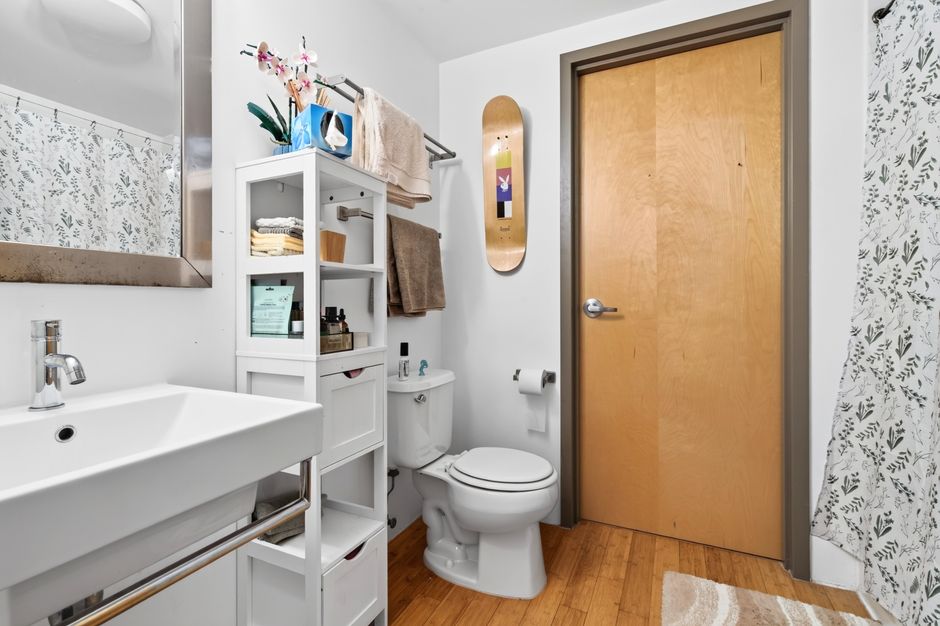 A stylish and organized bathroom interior in a Boston apartment with contemporary fixtures.