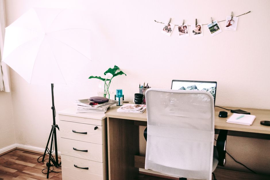 Stylish home office setup with a laptop, desk, and decorative accents, perfect for remote work.