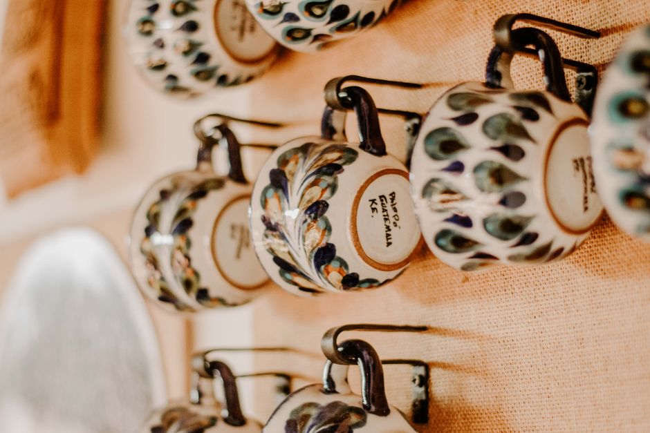 Close-up of decorative ceramic cups hanging on a wall in Ciudad de Guatemala, Guatemala.
